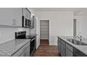 Modern kitchen with gray cabinets, granite countertops, and stainless steel appliances at 1104 Middlecrest Dr, Rocky Mount, NC 27804