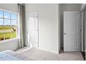 Well-lit bedroom with a large window, carpet flooring, and a spacious closet at 1113 Middlecrest Dr, Rocky Mount, NC 27804