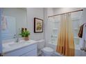Clean bathroom with a shower/tub combo, white vanity, and a window at 1116 Middlecrest Dr, Rocky Mount, NC 27804