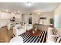 Open concept living room and kitchen with hardwood floors, and modern furniture at 1134 Chestnut Bluff, Apex, NC 27502