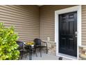 Small front porch with two wicker chairs and a small table at 116 Rosebud Lane Ln, Durham, NC 27704