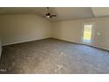 Bright living area with carpet and access to backyard at 148 Phil Jack Rd, Dunn, NC 28334