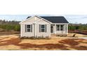 Inviting single-story home with neutral siding, black shutters, and a well-manicured lawn at 150 Brookhaven Dr, Spring Hope, NC 27882