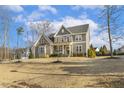 Charming two-story home featuring stone and siding exterior with a covered front porch at 1625 Banks View Dr, Raleigh, NC 27603