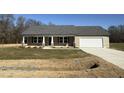 Newly built ranch home with gray roof, attached garage, and landscaping at 186 Phil Jack Rd, Dunn, NC 28334