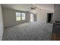 Open living room with vaulted ceiling, gray carpet, and ceiling fan at 186 Phil Jack Rd, Dunn, NC 28334