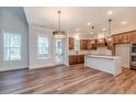 Open kitchen with an island, wood cabinets, and stainless steel appliances at 191 Landon Ridge, Sanford, NC 27330