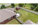 Aerial view of backyard featuring a fenced yard, red shed, and patio area at 2001 Bunnfield Dr, Zebulon, NC 27597