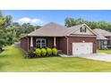 Lovely brick home with well-kept lawn and attached two-car garage at 2001 Bunnfield Dr, Zebulon, NC 27597
