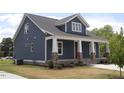 Gray siding, stone accents, and a covered porch at 211 W Harnett St, Dunn, NC 28334