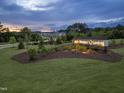 The Georgia's Landing community sign glows at dusk with lush landscaping and new homes in the background at 227 Augusta Pond Way # 159, Raleigh, NC 27603
