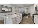 Modern kitchen with white cabinets, quartz countertops, and an island at 2328 Sugar Cone Way, Fuquay Varina, NC 27526