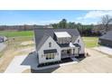 Expansive aerial view of a modern farmhouse-style home with ample yard space in a lush, green neighborhood at 321 Bud Wall Rd, Youngsville, NC 27596