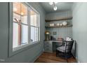 Charming office with a view, built-in shelves, and stylish decor creating an ideal workspace at 321 Bud Wall Rd, Youngsville, NC 27596