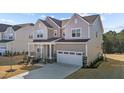 Two-story house with gray siding, white garage door, and a stone facade at 355 High Woods Rdg, Chapel Hill, NC 27517