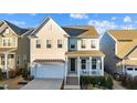 Charming two-story home with a welcoming front porch and attached two-car garage at 413 Holding Creek Dr, Wake Forest, NC 27587