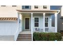 Charming front porch with white railings, a dark brown door, and brick steps at 413 Holding Creek Dr, Wake Forest, NC 27587
