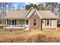 Charming single-story home with a brick facade, covered porch, and cozy curb appeal at 521 N Franklin Dr, Sanford, NC 27330