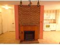 Brick fireplace in living room with kitchen view at 626 Pine Ridge Pl Pl, Raleigh, NC 27609