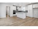 Spacious open-concept kitchen with a large island, stainless steel appliances, and hardwood floors at 708 Georgias Landing Pkwy # 14, Raleigh, NC 27603