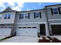 View of the exterior of a two-story home with a white garage door at 7113 Hubner Pl # 20, Cary, NC 27519