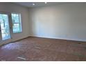 Bright living room with a window and door letting in plenty of natural light at 7115 Hubner Pl # 21, Cary, NC 27519
