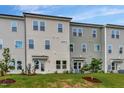 Townhome showcasing light beige siding, lots of windows and a grassy backyard at 7117 Hubner Pl # 22, Cary, NC 27519
