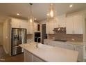 Modern kitchen featuring stainless steel appliances, a quartz countertop, and pendant lighting at 7117 Hubner Pl # 22, Cary, NC 27519