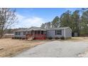 Gray siding ranch home with red accents and a covered porch at 7228 Pecan Tree St, Willow Springs, NC 27592