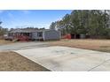 House exterior, featuring gray siding and a large concrete driveway at 7228 Pecan Tree St, Willow Springs, NC 27592