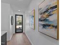 Bright entryway with light wood floors and modern artwork at 808 Culpepper Ln, Raleigh, NC 27610
