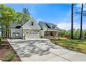 Spacious driveway leading to a charming two-story home with a two-car garage and lush green lawn at 810 Maggie Way, Wendell, NC 27591