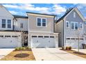 Attractive townhouses with white garage doors, landscaped yards, and classic architectural features at 8946 Kennebec Crossing Dr # 79, Angier, NC 27501