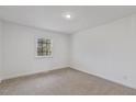 Bright bedroom with neutral carpeting and ample natural light at 905 Corona St, Durham, NC 27707