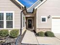 Welcoming front entrance with stone accents and a charming wreath at 13 Needham Ln, Clayton, NC 27527