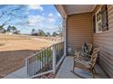 Front porch with rocking chairs and a view of the yard at 1424 Old Watkins Rd, Raleigh, NC 27616