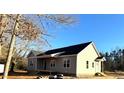 Side view of new construction home, showcasing gray siding and landscaping at 170 Squirrel Path Way, Roxboro, NC 27574