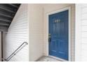 Condo building entry with blue door and stairs at 1801 Trailwood Heights Ln # 201, Raleigh, NC 27603