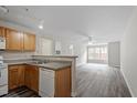 Open living room with wood-look floors and kitchen at 1801 Trailwood Heights Ln # 201, Raleigh, NC 27603