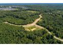 Aerial view of community with roads and lush green forest at 20 Lila Dr, Pittsboro, NC 27312