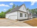 Modern farmhouse-style home with a spacious driveway leading to an attached two-car garage at 250 Ellington Rd, Graham, NC 27253