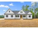 Charming, newly built home with a light-colored exterior, a dark roof, and a inviting front porch at 250 Ellington Rd, Graham, NC 27253
