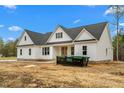 Charming new construction home with white siding, a dark roof, and bright blue sky at 250 Ellington Rd, Graham, NC 27253