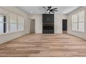 Spacious living room features modern fireplace, ceiling fan and large windows at 250 Ellington Rd, Graham, NC 27253