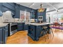 Spacious kitchen with island, stainless steel appliances, and dark blue cabinetry at 2800 Peachleaf St, Raleigh, NC 27614