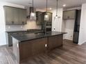 Spacious kitchen with a large island, stainless appliances, and modern lighting at 3271 Roundly Rd # 9, New Hill, NC 27562