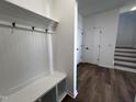 View of a bright mudroom with white wainscoting and built-in bench at 3271 Roundly Rd # 9, New Hill, NC 27562