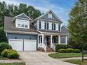 Two-story home with gray siding, white trim, and a two-car garage at 401 Streamwood Dr, Holly Springs, NC 27540