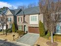 Two-story brick home with a brown garage door and landscaping at 4033 Periwinkle Blue Ln, Raleigh, NC 27612