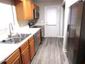 Kitchen with stainless steel appliances and light wood cabinets at 409 James Toney Dr, Elon, NC 27244